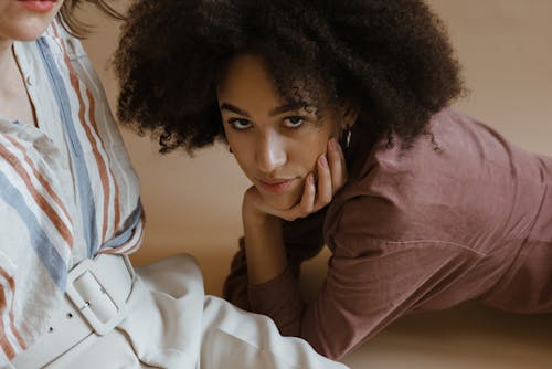 Woman in Brown Long Sleeve Shirt Looking at the Camera