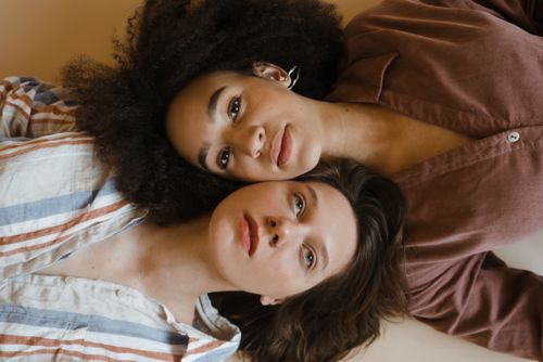 Free Artistic portrait of two women celebrating diversity and friendship. Stock Photo