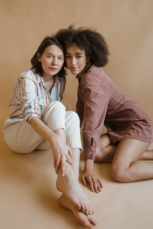 Women Looking at the Camera while Sitting on the Floor
