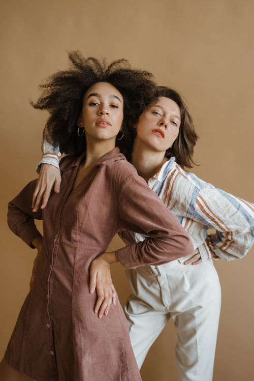 Free Two diverse women confidently pose in a studio, showcasing style and empowerment. Stock Photo