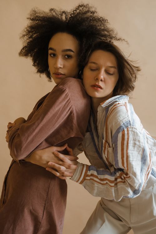 Free Serene portrait of two diverse women embracing, showcasing style and connection. Stock Photo