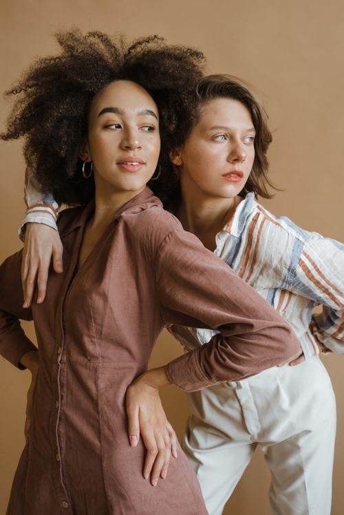 Free Two women exuding confidence and style in a studio shoot. Stock Photo