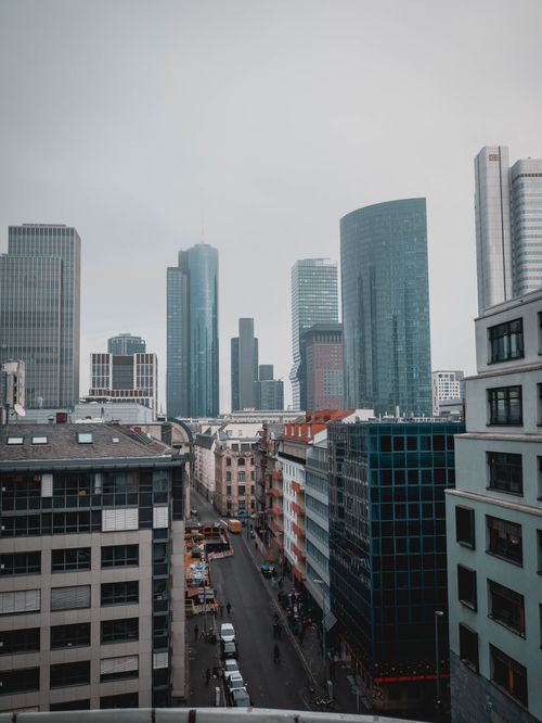 Free Exterior of city district with wide asphalt road between high rise buildings with glass walls and contemporary structures Stock Photo
