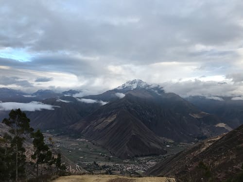 Aerial View of Mountains Under White Clouds