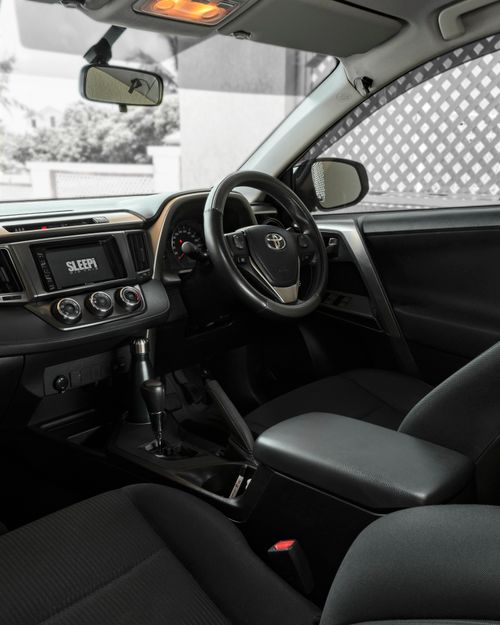 Free Sleek modern car interior showing steering wheel and dashboard in focus. Stock Photo
