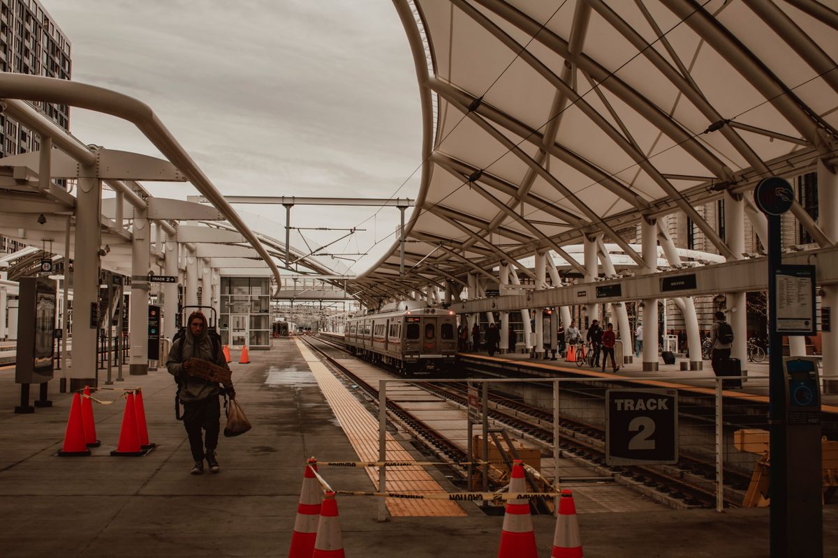 Bustling train station scene with commuters in Denver, highlighting modern public transportation. Illustrative editorial photograph.