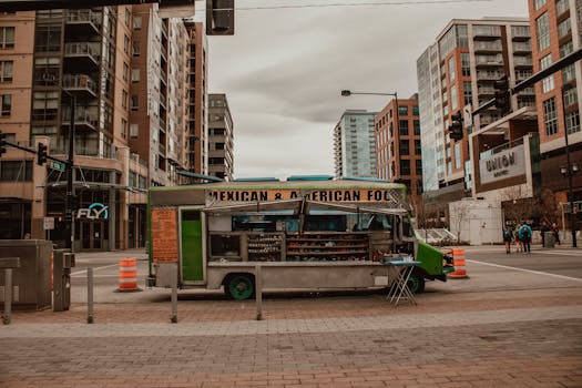A food truck offering Mexican and American cuisine in a bustling urban street setting.