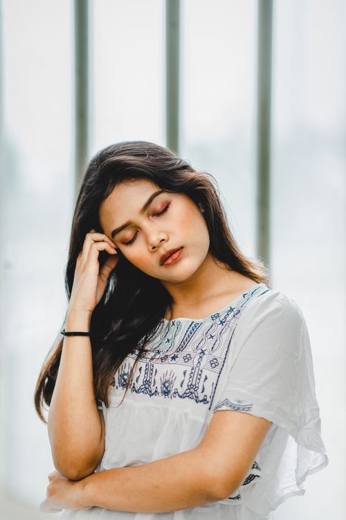 Free A serene portrait of a young woman with her eyes closed, exuding thoughtfulness. Stock Photo