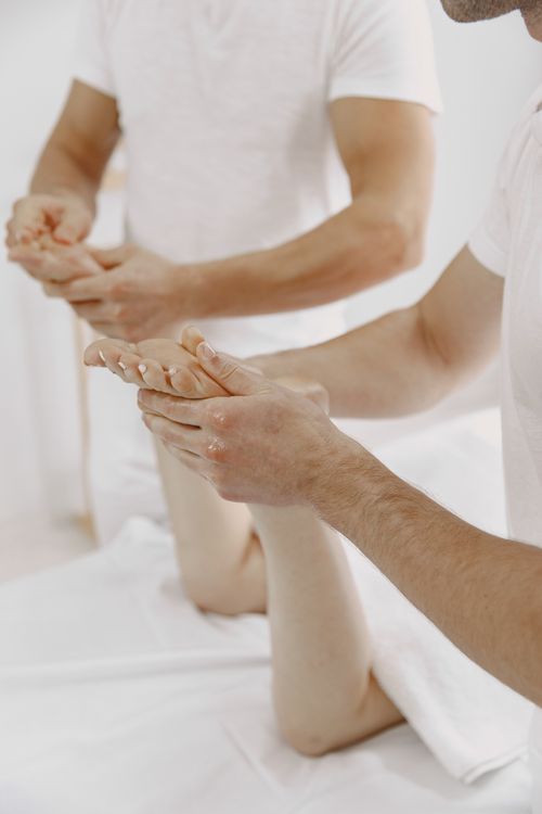Free Close-up of a masseur giving a professional hand massage to a client in a serene setting. Stock Photo