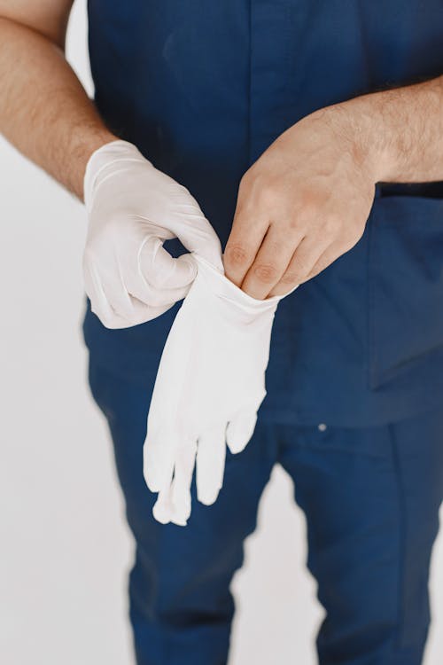 Person Wearing White Medical Gloves