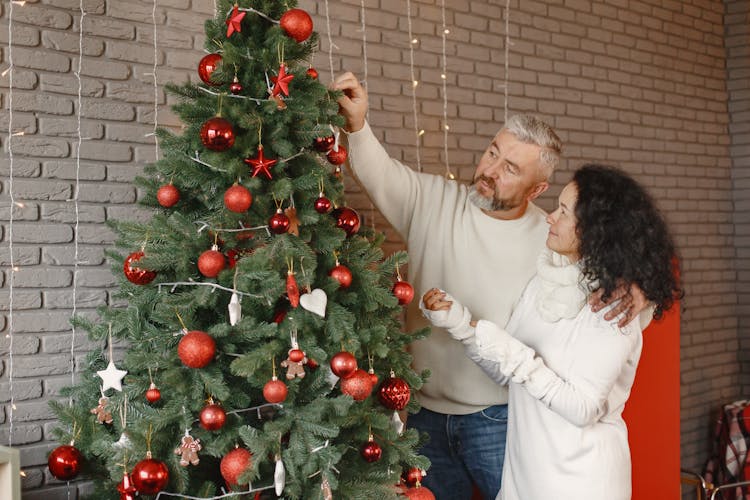 Couple Decorating Christmas Tree Together