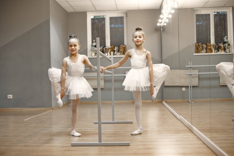 Ballerinas Holding Their Toes