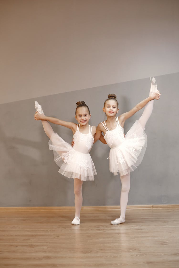 Young Ballerinas Standing On One Leg