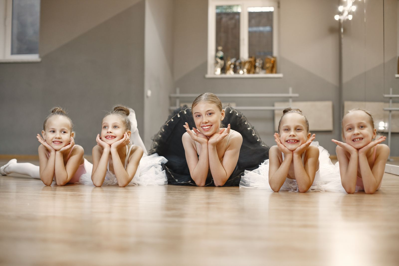 New dance class participants practicing basic steps together in a bright studio