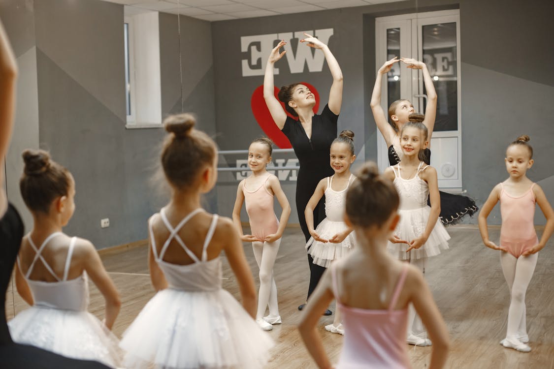 Free Young Ballerinas Dancing with their Teacher Stock Photo