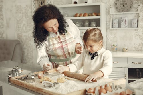 Free Girl Rolling Out Dough in Flour Stock Photo