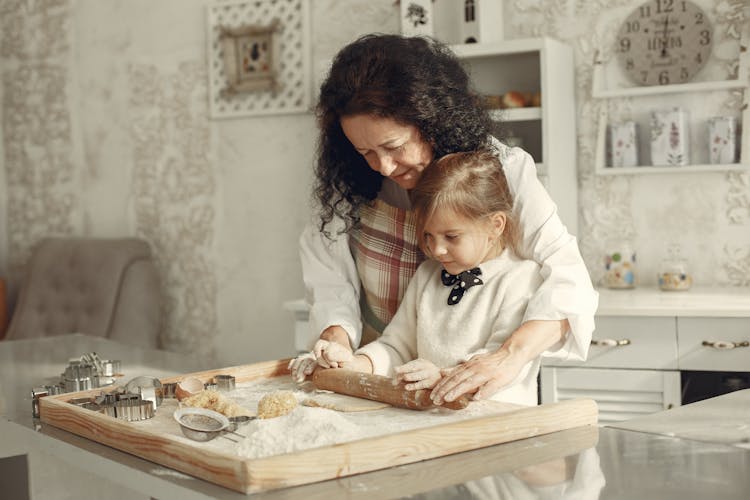 Woman And Girl Making Cookies Together