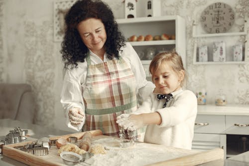 Woman and Child Making Dough in Kitchen
