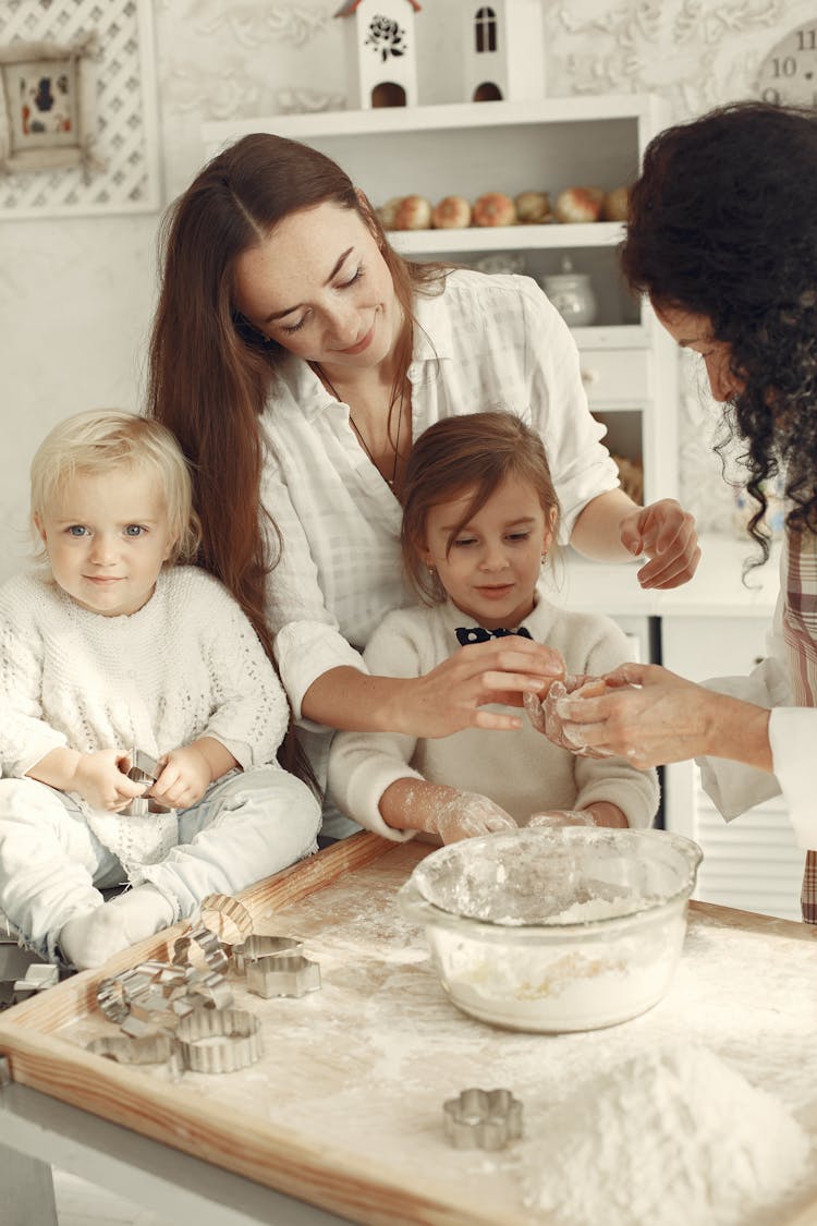 Women And Children Baking A Cake 