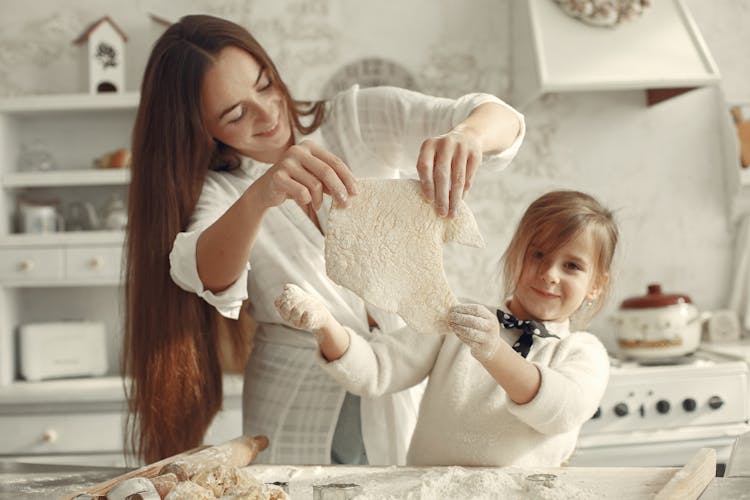 Mother And Daughter Baking Together In The Kitchen