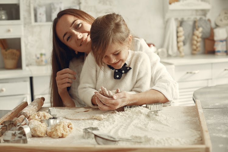 Woman Baking Cookies With Her Daughter 