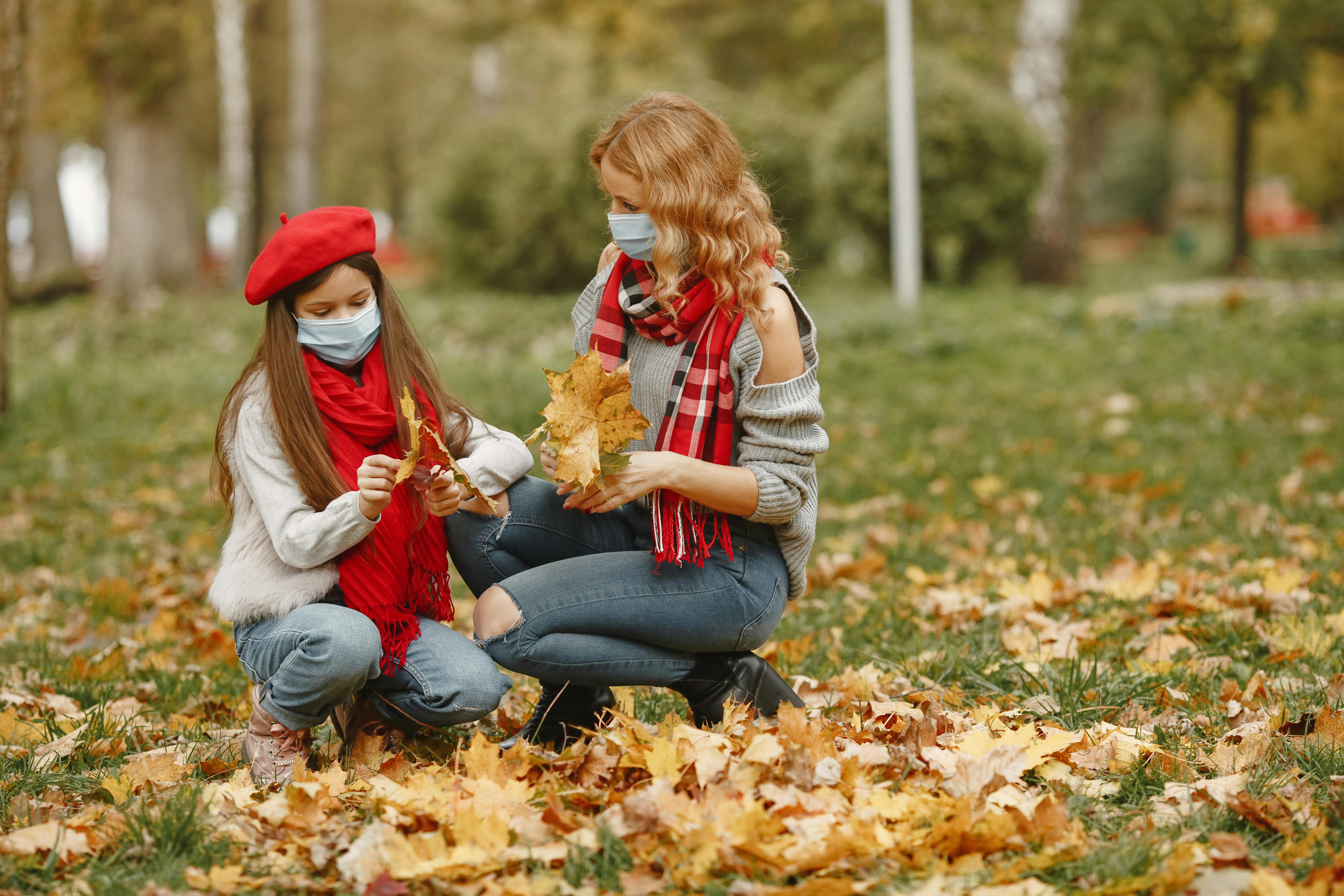 woman in gray sweater beside a girl