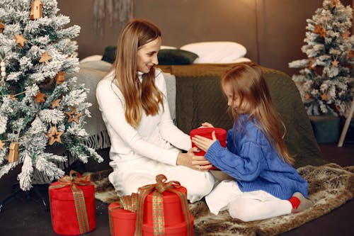 Girl Receiving ChriGift From Mother