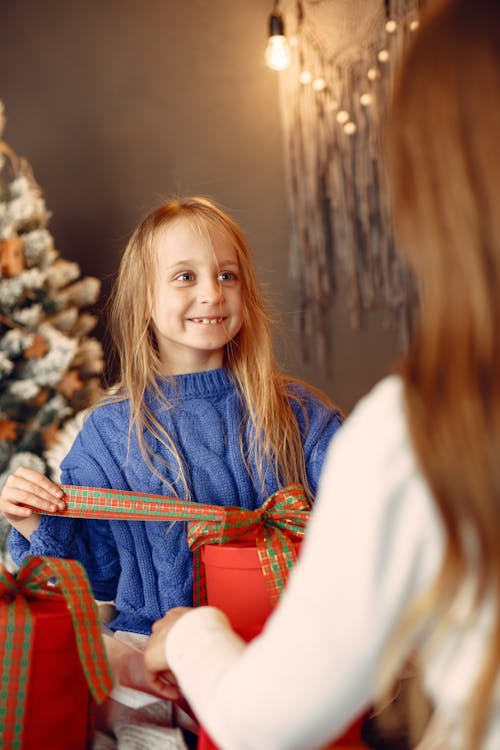 Free Girl Unwrapping a Gift Stock Photo