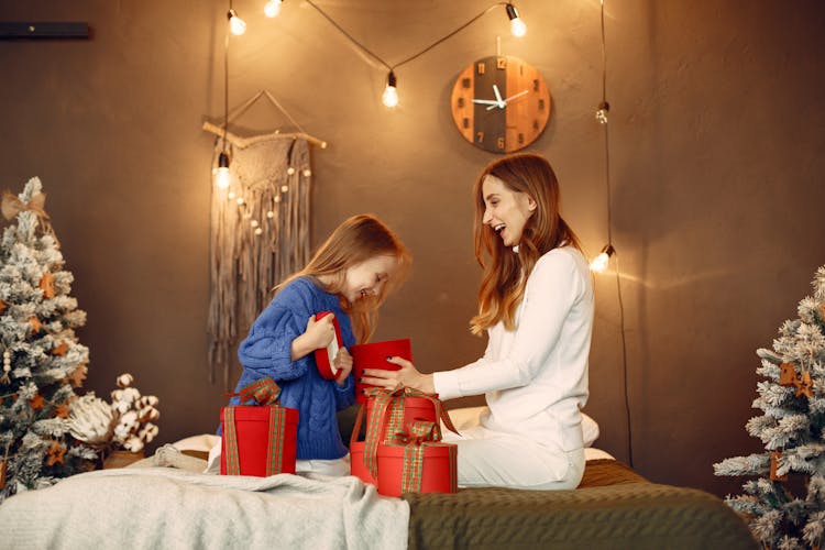 Mother And Daughter Opening Christmas Presents