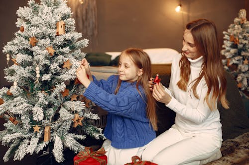 Daughter and Mother Decorating Christmas Tree
