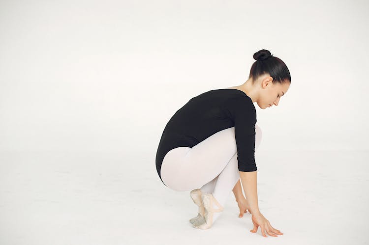 Ballerina Squatting In Tiptoed Position