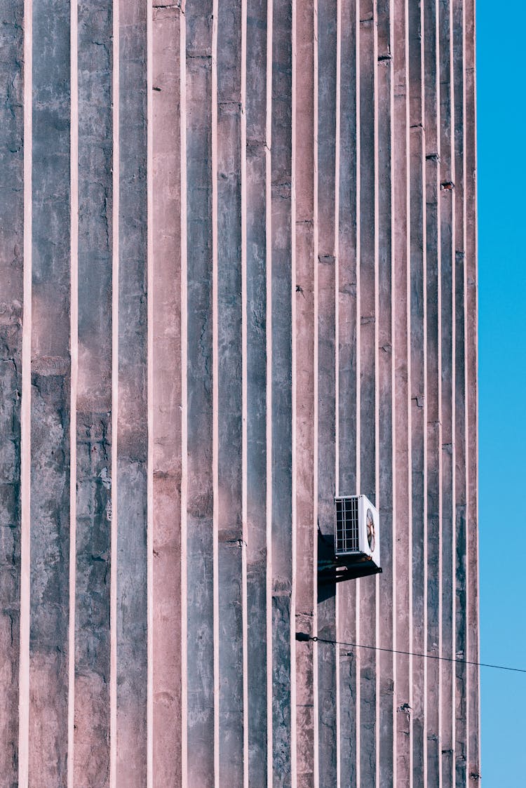 The Outdoor Unit Of An Air Conditioner On The Wall Of A Building