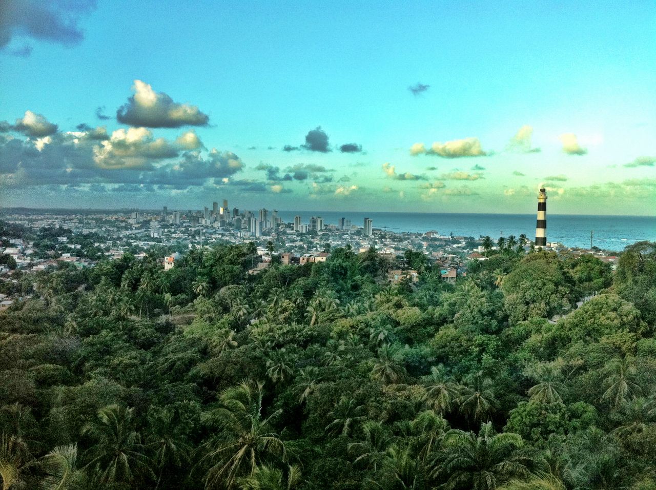 a breathtaking view of olinda with lush greenery and city skyline agai