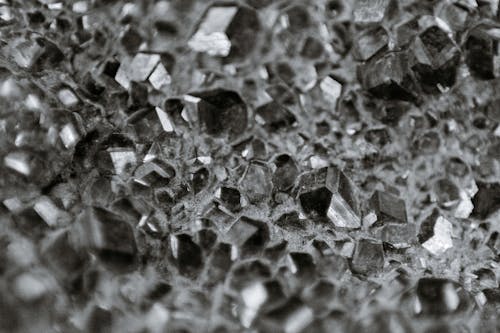 Black and white surface made of heap of minerals of geometric shapes and different sizes