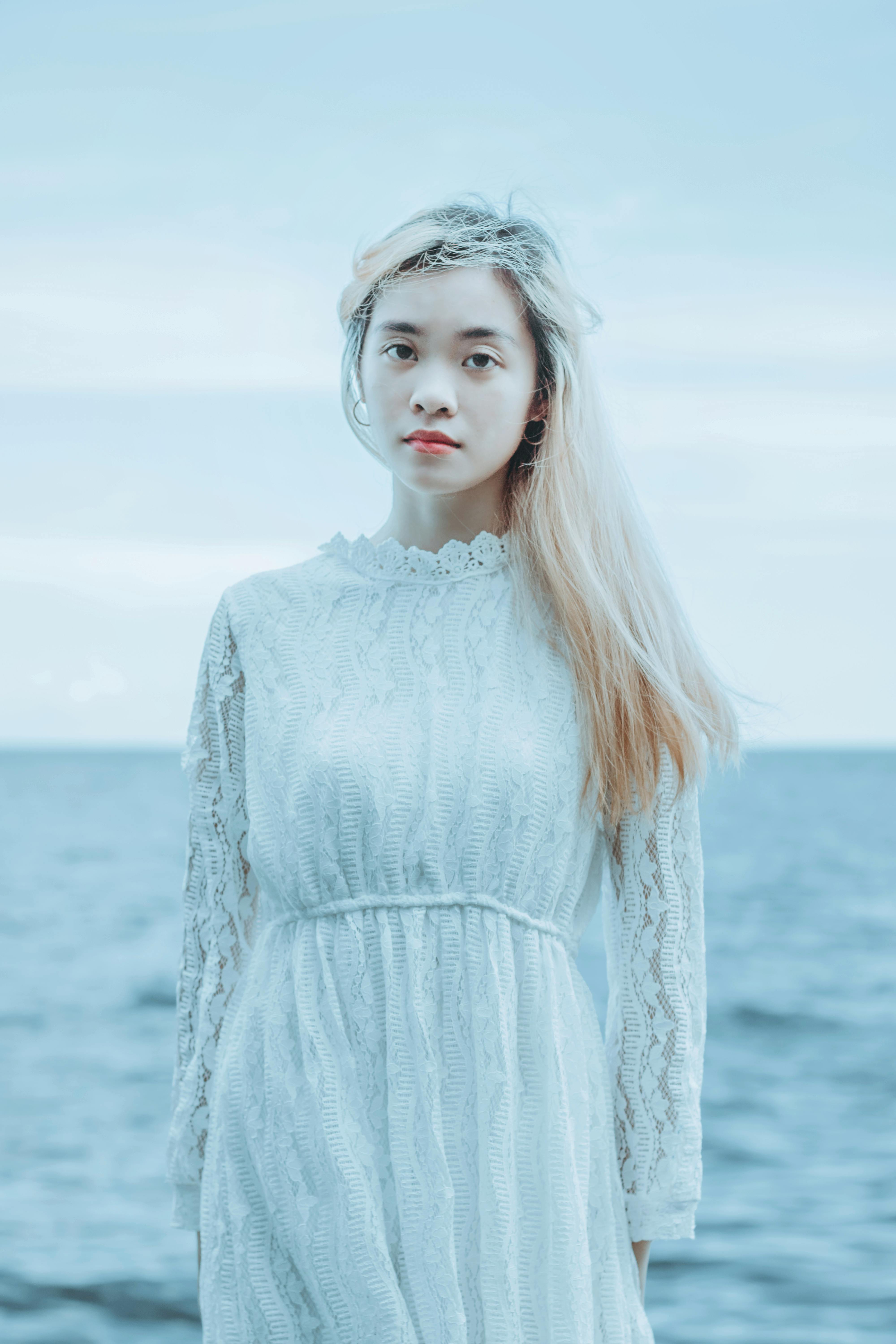 Attractive Asian woman sitting in water · Free Stock Photo