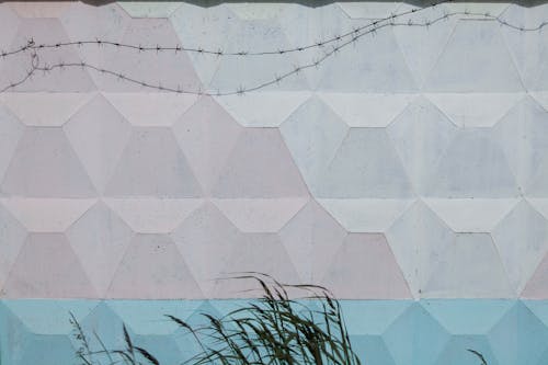 Abstract background of geometric wall with barbed wire