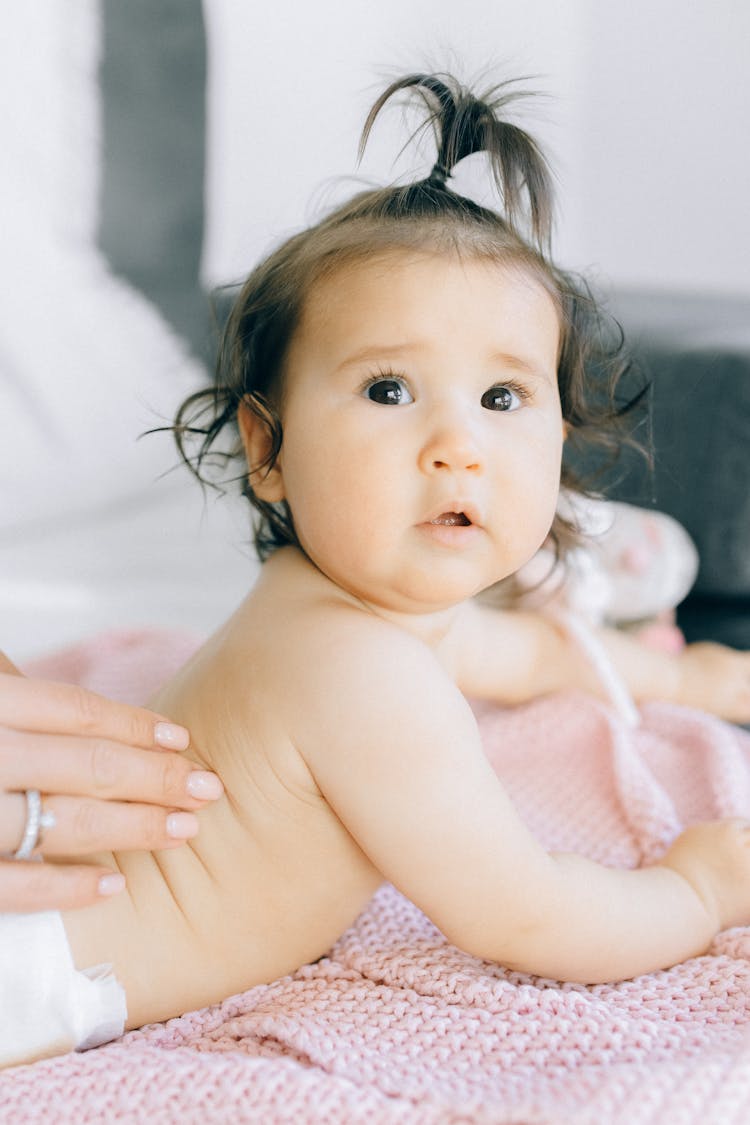 Topless Baby Lying On Bed