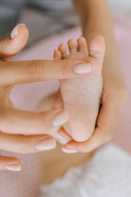 Person Touching Baby's Foot