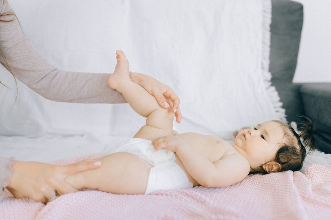 Free Baby in White Diaper Lying on Bed Stock Photo