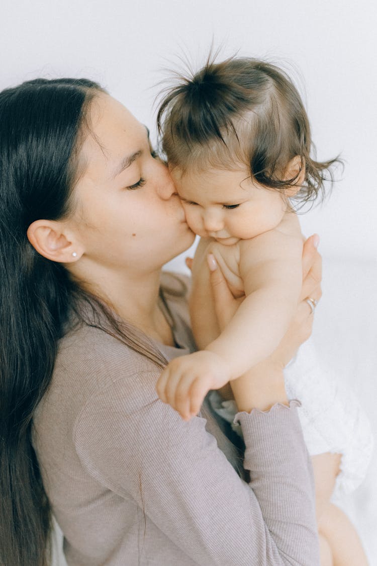 Woman Kissing A Baby