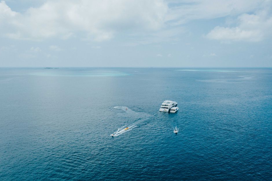 A traditional Maldivian dhoni boat on a dolphin cruise at sunset