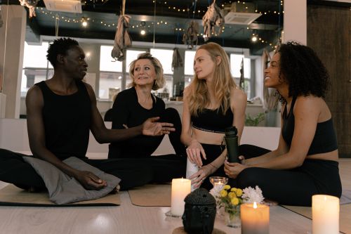 Free A diverse group of adults engaged in relaxation and meditation in a cozy yoga studio setting. Stock Photo
