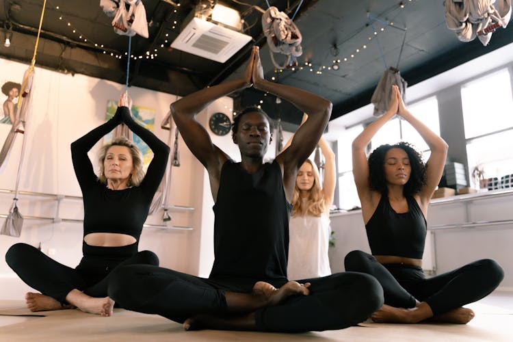 People Meditating In A Yoga Class