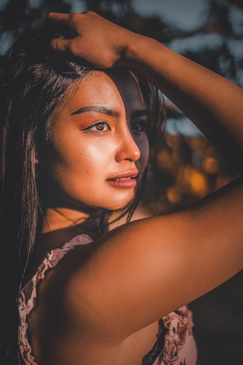 Concentrated young woman touching head