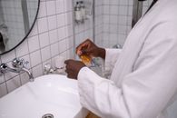 Person in White Dress Shirt Holding Orange Fruit