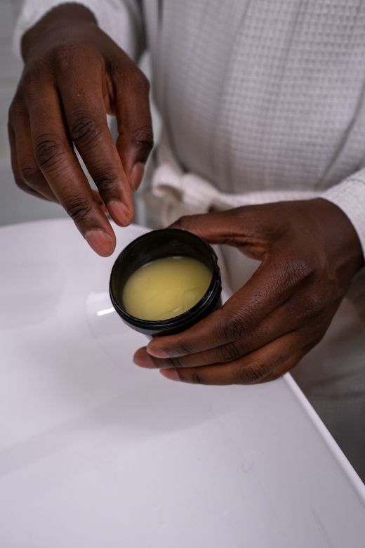 Hands holding a jar of body balm &mdash; photo by cottonbro studio on Pexels
