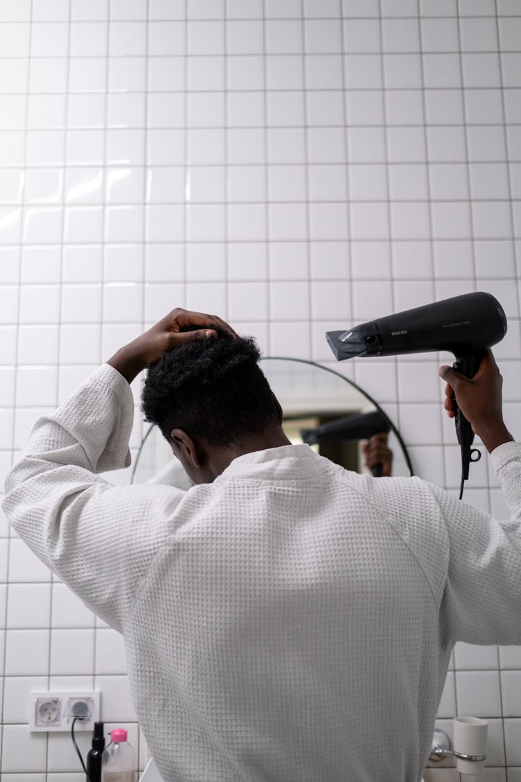 Man In White Bathrobe Holding Black Blow Dryer