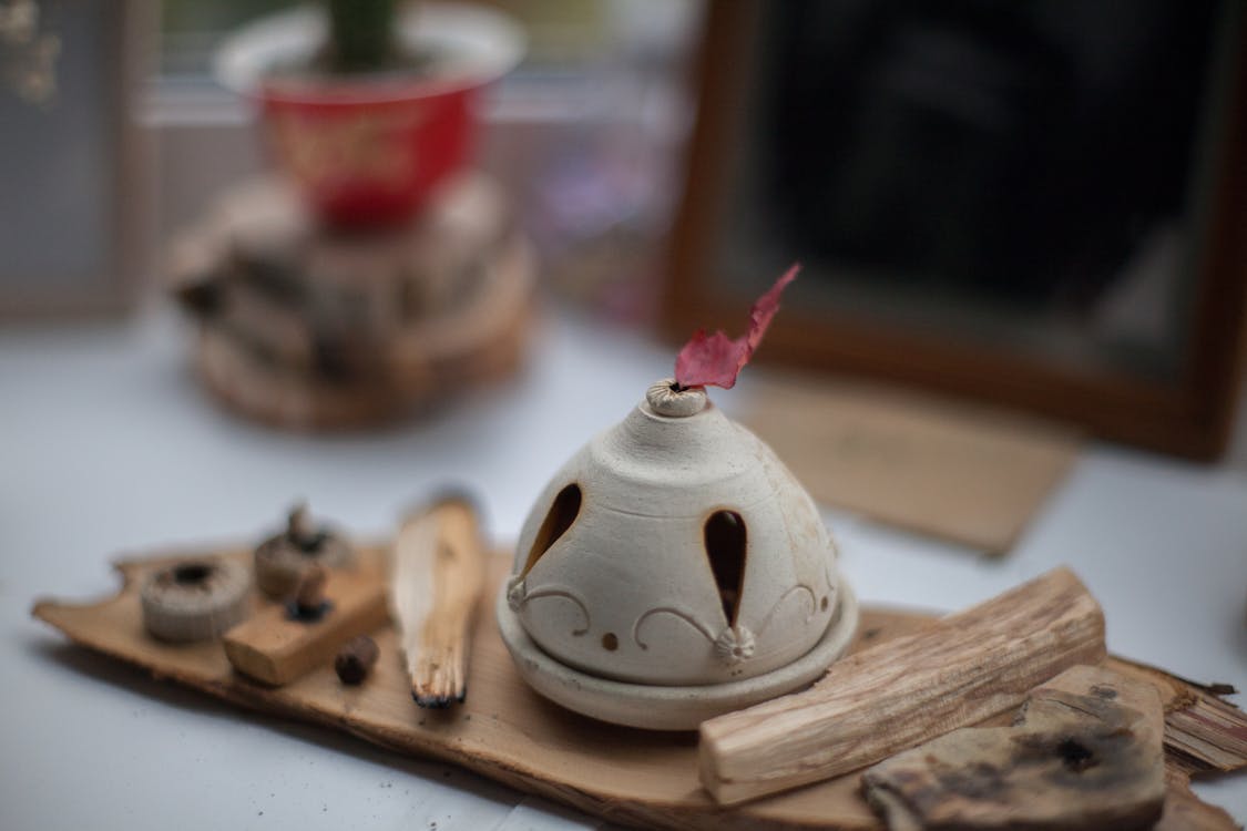 Free Aromatherapy lamp with wooden sticks placed on windowsill Stock Photo