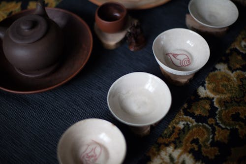 Free From above set of oriental tea cups placed on rug with teapot during traditional ceremony Stock Photo