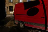 Dirty minibus on pedestrian crossing of road